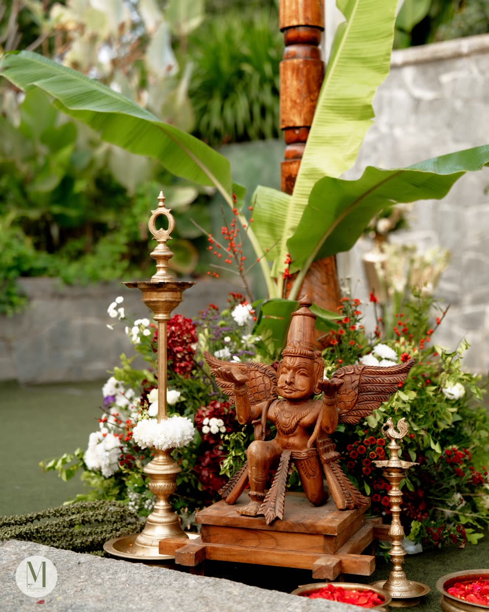 A traditional South Indian table setting with brass lamps and banana leaves