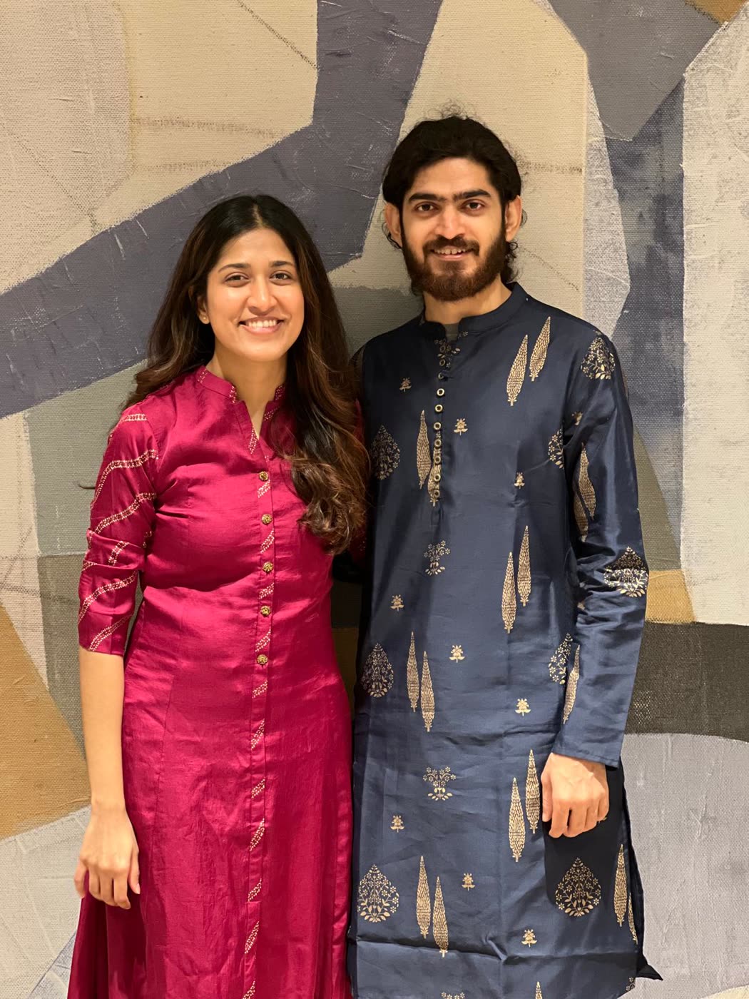 Abirami and Prateek in a pink kurta and navy sherwani
