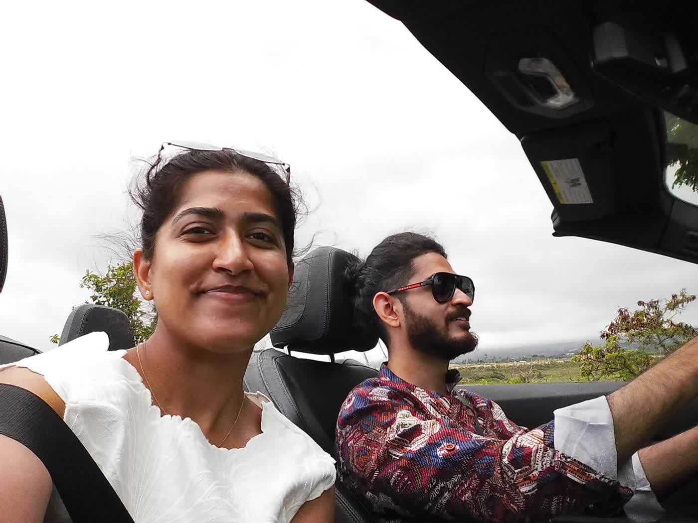 Abirami and Prateek on a drive with the roof down