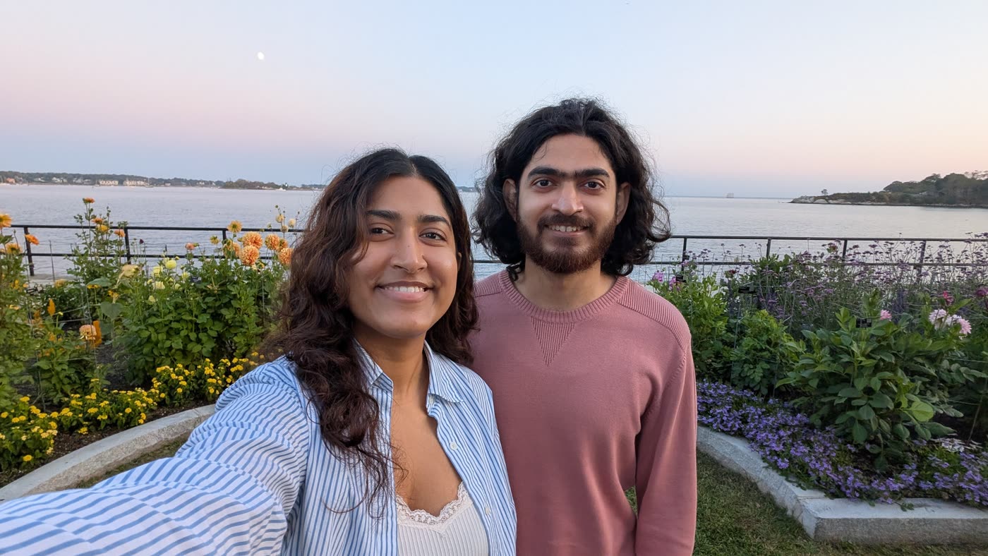 Abirami and Prateek in a garden by the water